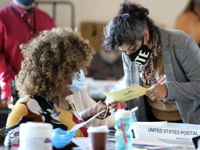 Workers in Atlanta count ballots