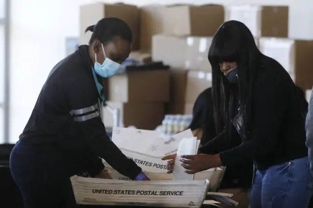 Officials in Fulton County count absentee ballots at State Farm Arena in Atlanta, Georgia, USA, 06 November 2020.