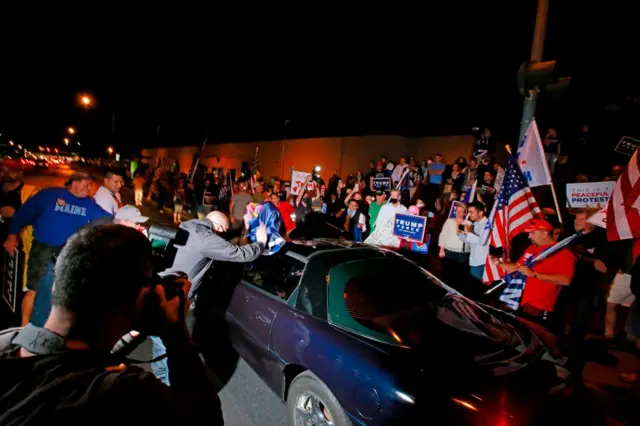 Pro-Trump protesters outside a vote-counting centre clashed with a Biden-supporting driver on Thursday night