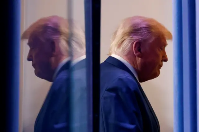 Donald Trump reflected in a window