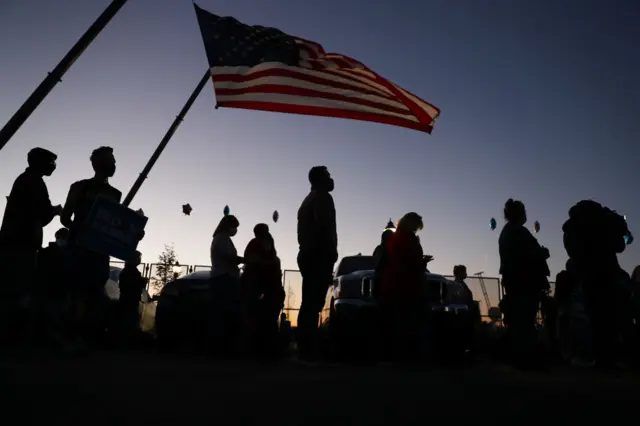 Supporters of Democratic presidential nominee Joe Biden gather near the parking lot at the Chase Center where Mr. Biden is expected to make an announcement to the Nation on November 06, 2020 in Wilmington, Delaware