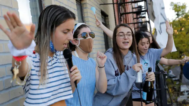 Women celebrate media announcing that Democratic US presidential nominee Joe Biden has won the 2020 U.S. presidential election in Alphabet City neighborhood of Manhattan, in New York City, U.S. November 7, 2020.