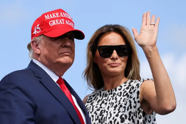 First lady Melania Trump waves next to US President Donald Trump