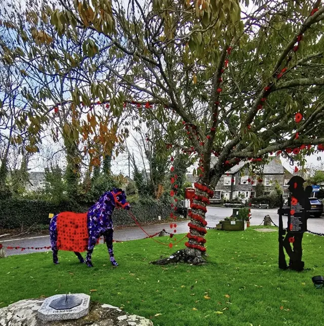 Knitted poppy structures created by the Crantock community