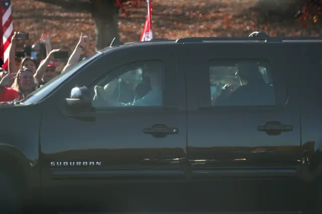 Trump waves at supporters outside his golf club