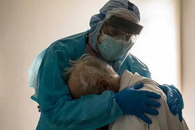 Dr Joseph Varon hugs and comforts a patient in the Covid-19 intensive-care unit (ICU) during Thanksgiving