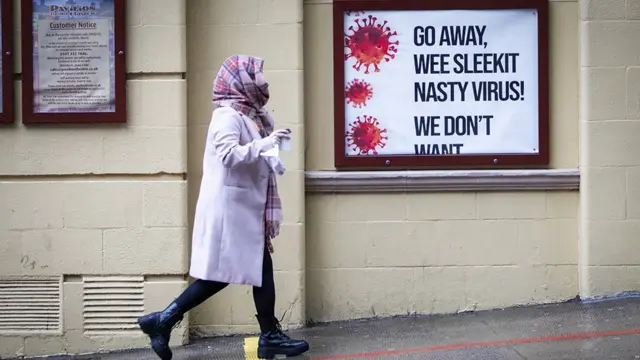 A woman walking on a street in Glasgow