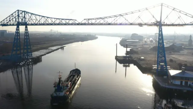 Dredger sails under the Transporter Bridge