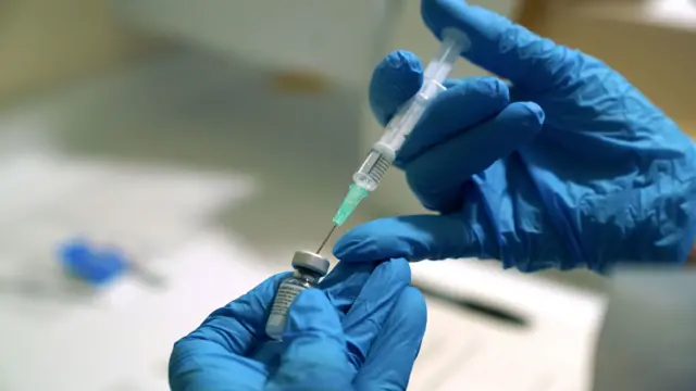 A needle is filled from a phial of Pfizer/BioNTech Covid-19 vaccine at the Royal Victoria Infirmary in Newcastle