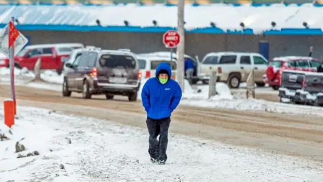 A person walks through the snow in Canada