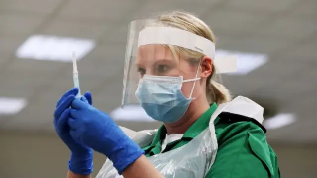 Person holding a syringe