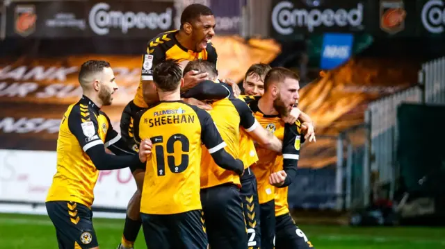 Newport County players celebrate a goal