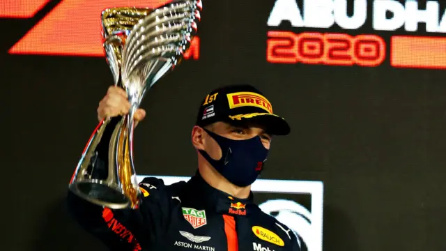 Max Verstappen holds aloft the trophy