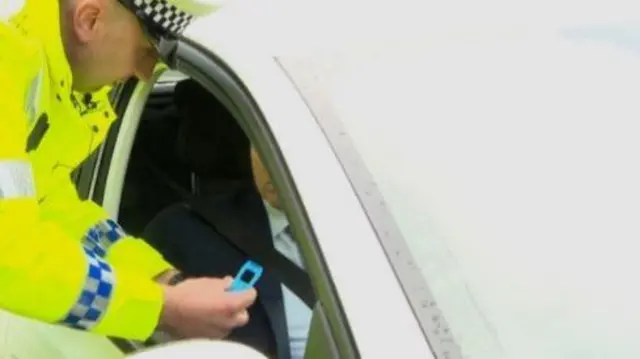 Police officer with drug testing kit