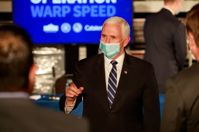 Mike Pence visits a factory where vials are being filled with vaccine