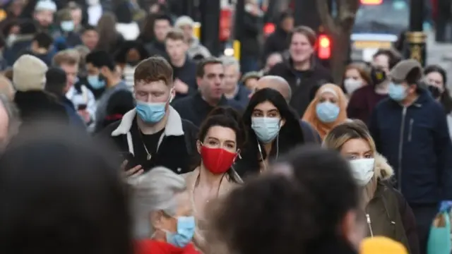 Crowds of people walking down Oxford Street