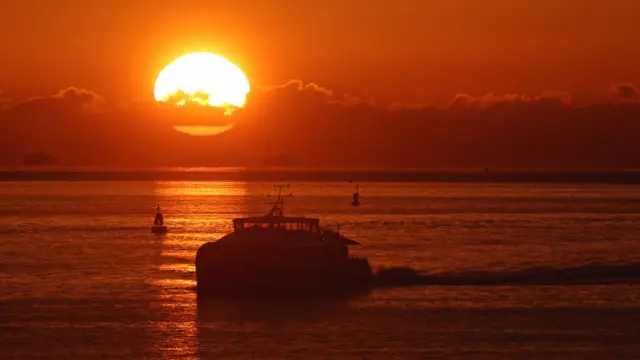 The sun rises over The Solent, which separates the mainland from the Isle of Wight, after the second national lockdown ended and England entered a strengthened tiered system of regional coronavirus restrictions.