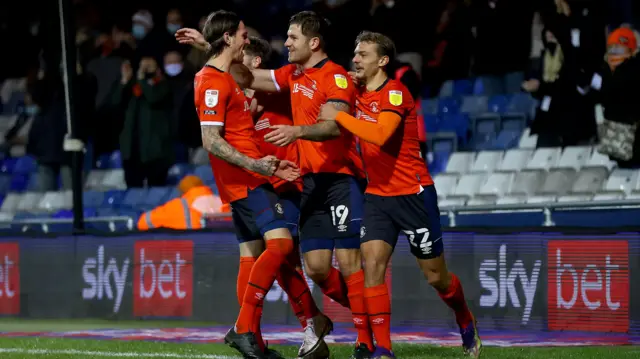 James Collins celebrates scoring Luton's third goal against Norwich