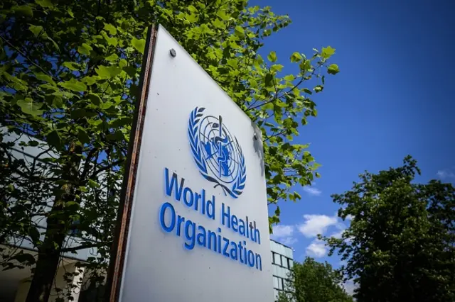 This picture taken on April 24, 2020 shows a sign of the World Health Organization (WHO) in Geneva next to their headquarters, amid the COVID-19 outbreak, caused by the novel coronavirus