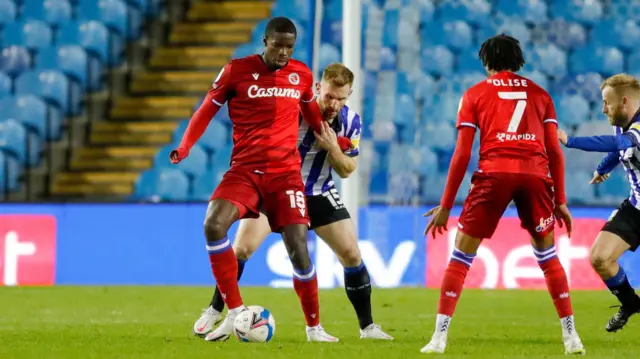 Reading forward Lucas Joao shields the ball from Sheffield Wednesday defender Tom Lees