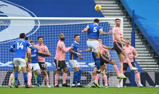 Lewis Dunk heads over the bar