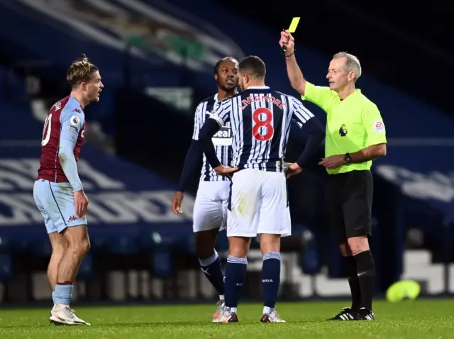 West Brom's Jake Livermore is shown a yellow card for a tackle on Aston Villa's Jack Grealish