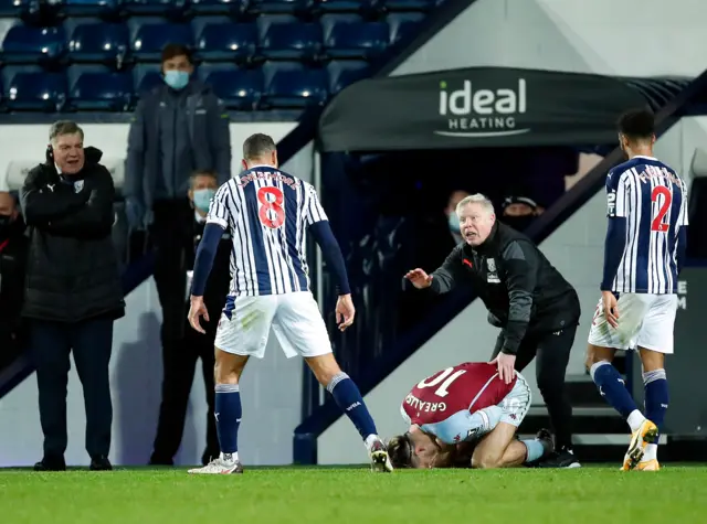 West Brom's Jake Livermore looks at Jack Grealish after fouling him