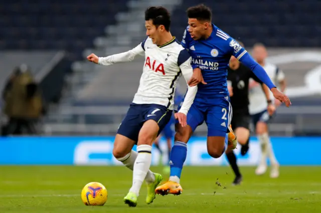 Tottenham's Son Heung-min holds off Leicester's James Justin