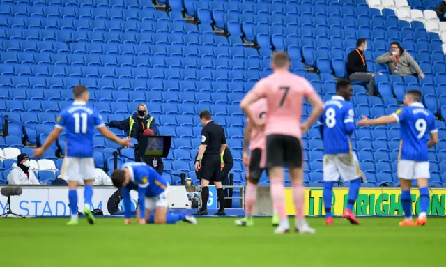 Peter Bankes looks at the VAR screen before sending John Lundstram off