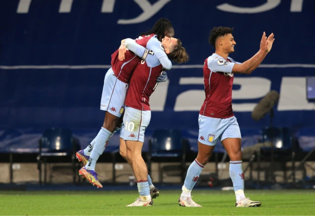 Jack Grealish celebrates with Bertand Traore