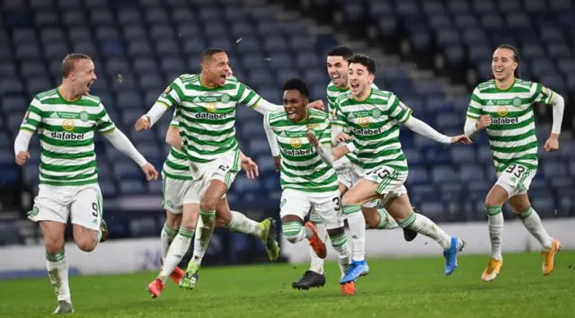 Celtic players celebrate as Kristoffer Ajer's penalty hits the net