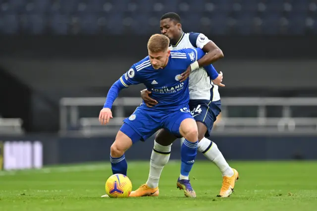 Leicester's Harvey Barnes holds off Tottenham's Serge Aurier