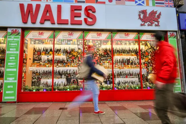 People walking past a shop in Cardiff