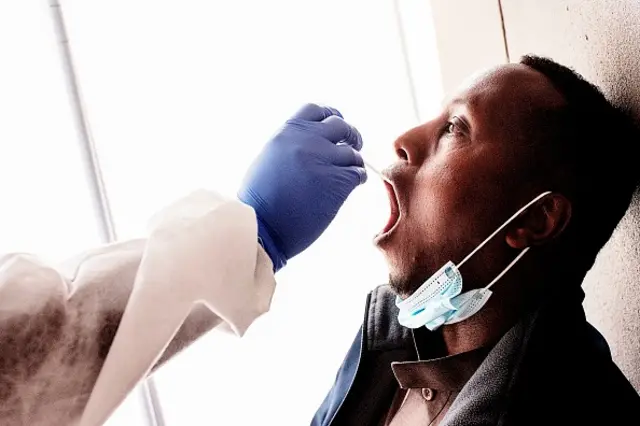 A nurse from Lancet Nectare hospital (L) performs a COVID-19 coronavirus test in Richmond, Johannesburg, on December 18, 2020