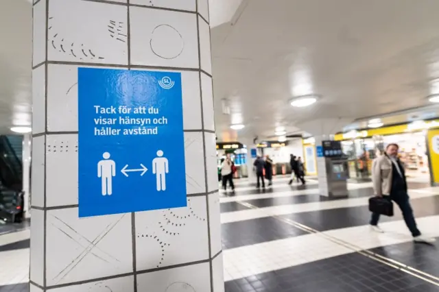 A sign reminding people to keep a distance at the Central station in Stockholm, Sweden, in November 2020