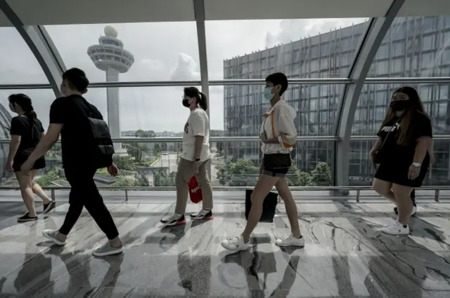 People walk through Singapore Airport