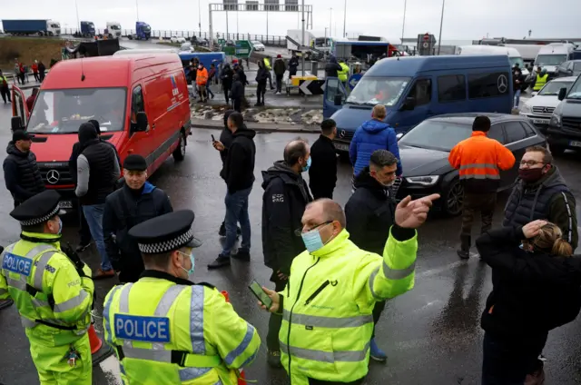 Drivers talk with police officers at the entrance of the Port of Dover