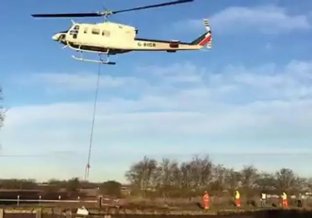 Helicopter dropping rocks