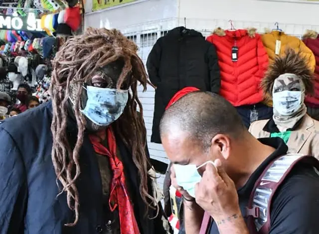 A Mexican wrestler tells an actor to don a mask in a performance meant to encourage the wearing of face coverings