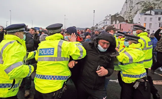 Police hold back drivers trying to enter the Port of Dover in Kent