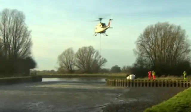 helicopter dropping rocks