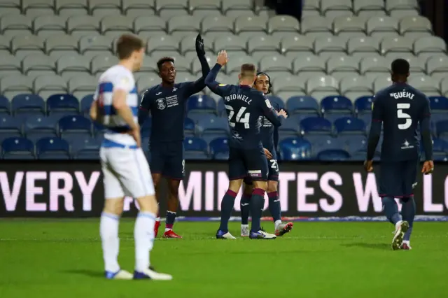 Swansea celebrate their second goal at QPR