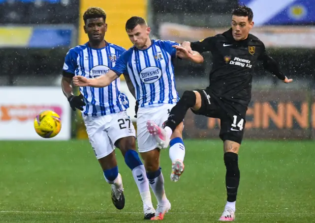 Livingston's Josh Mullin is challenged by Kilmarnock's Aaron Tshibola and Calum Waters