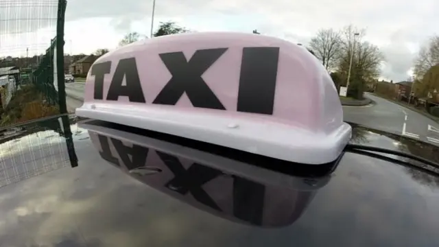 Taxi sign on car