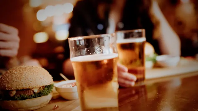 Beer and burgers on table