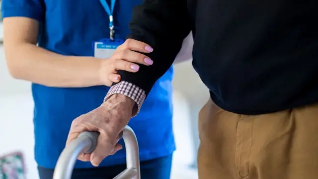 pensioner being helped