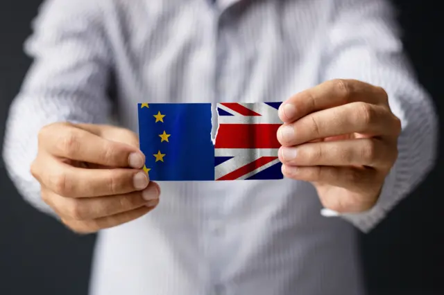 UK and EU flags being pulled apart