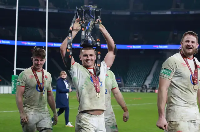 Henry Slade celebrates with the trophy on his head