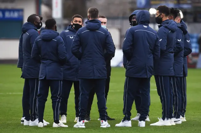 Rangers players gather for a pre-match chat on the pitch at the Global Energy Stadium