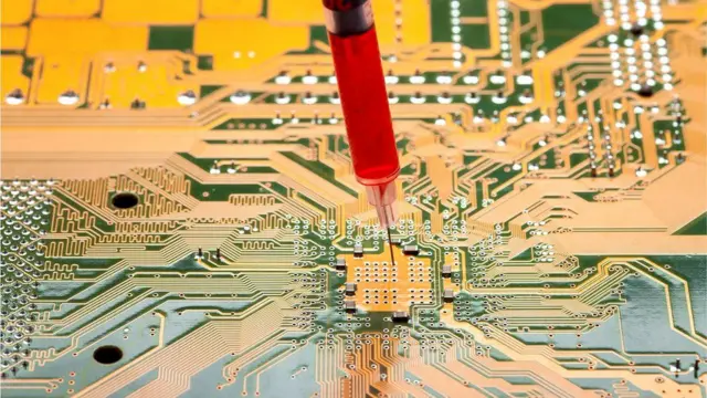 Picture of a needle going into a circuit board